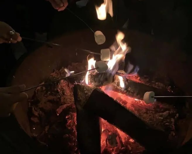 Family under the stars with well wrapped up in light colored clothes